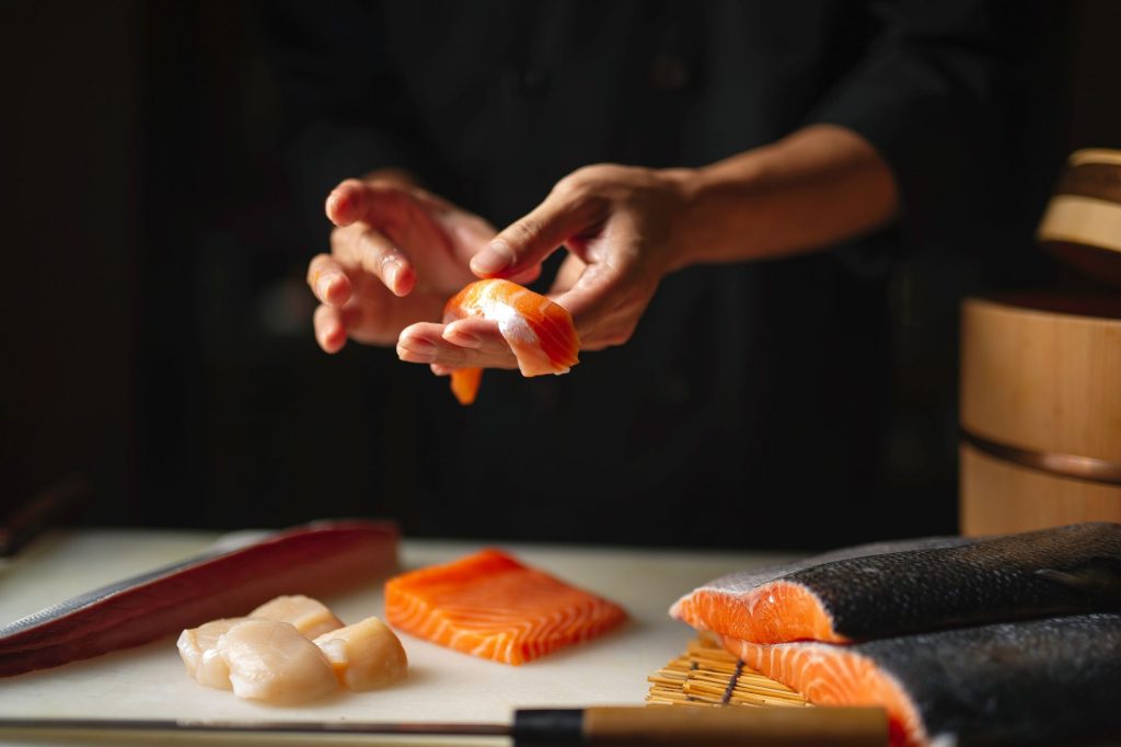 Japanese chef making sushi at restaurant